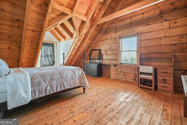 bedroom with lofted ceiling with beams, wood walls, wooden ceiling, and light wood-style floors