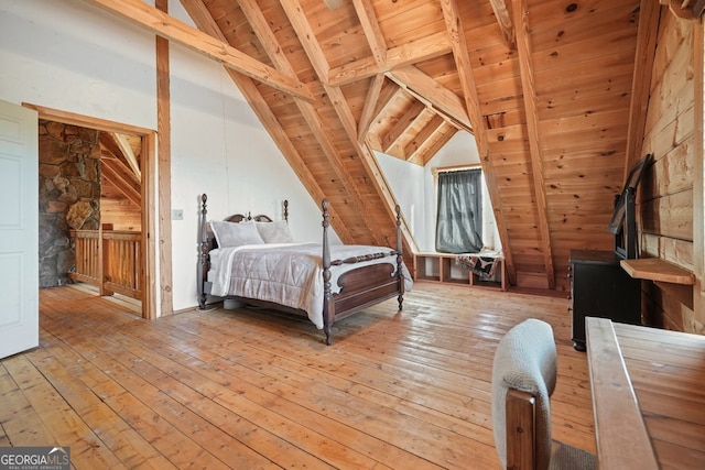 bedroom with wooden ceiling, vaulted ceiling with beams, and light wood-style flooring