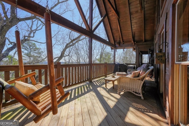 sunroom featuring vaulted ceiling with beams