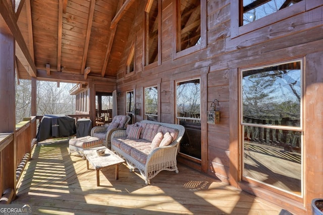 sunroom featuring vaulted ceiling with beams and wooden ceiling