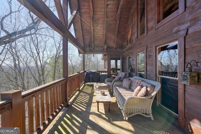 wooden terrace featuring outdoor lounge area and area for grilling