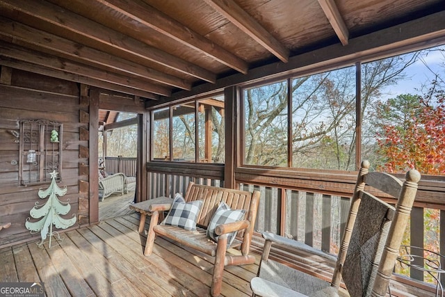 unfurnished sunroom with wood ceiling and beamed ceiling