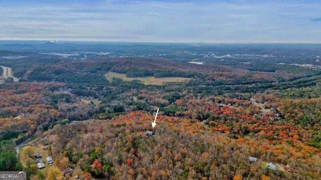 birds eye view of property featuring a wooded view