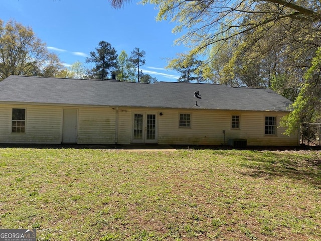 rear view of house with a yard and french doors