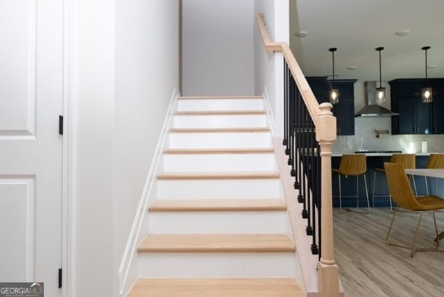 stairway featuring hardwood / wood-style flooring