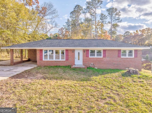 single story home with a front lawn and a carport