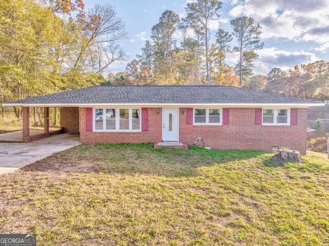 ranch-style house with a front lawn and a carport