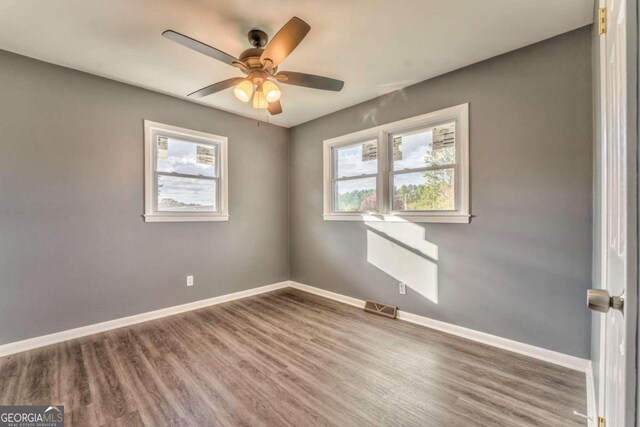 spare room featuring ceiling fan and wood-type flooring