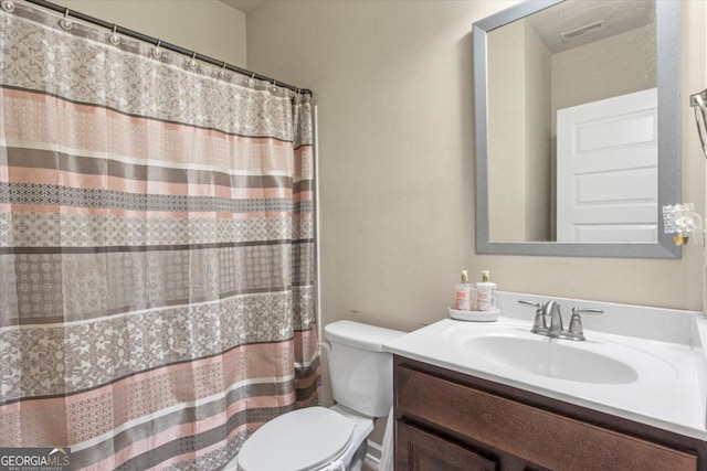 bathroom featuring vanity and toilet