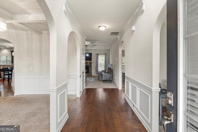 hall with wood-type flooring and crown molding