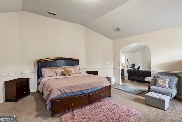 bedroom featuring light carpet and lofted ceiling