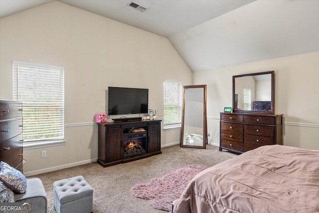 carpeted bedroom featuring lofted ceiling