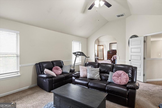 carpeted living room featuring ceiling fan and vaulted ceiling