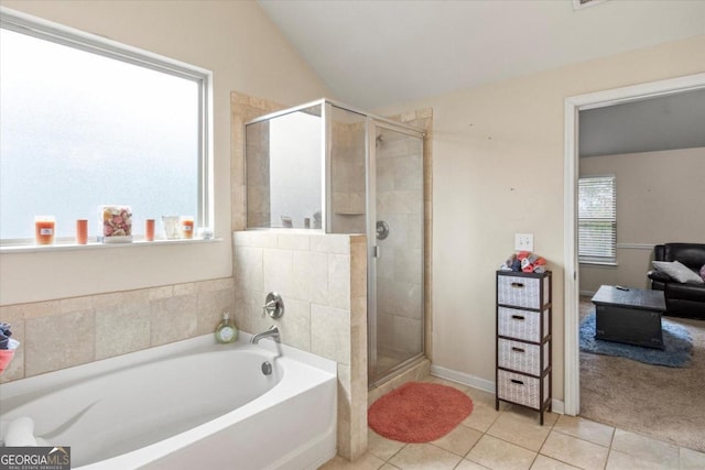 bathroom featuring tile patterned flooring, vaulted ceiling, and plus walk in shower