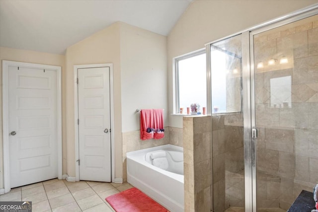 bathroom with tile patterned floors, vaulted ceiling, and shower with separate bathtub