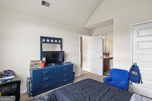 carpeted bedroom featuring connected bathroom and vaulted ceiling