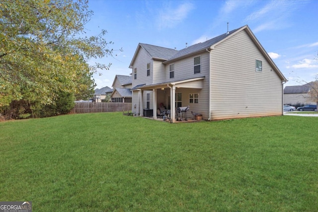 rear view of property with a patio area and a yard