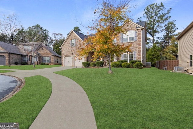 view of front of property with central air condition unit, a front lawn, and a garage