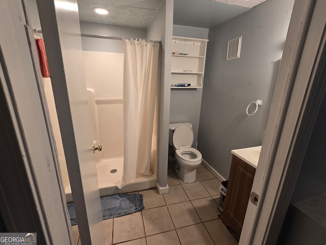 bathroom with toilet, vanity, tile patterned floors, and curtained shower