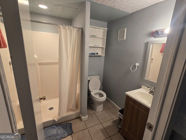 bathroom featuring tile patterned flooring, vanity, a shower with shower curtain, and toilet