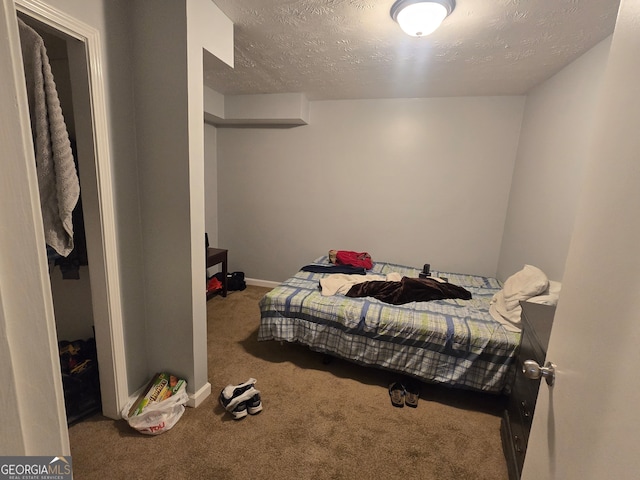 bedroom featuring carpet and a textured ceiling