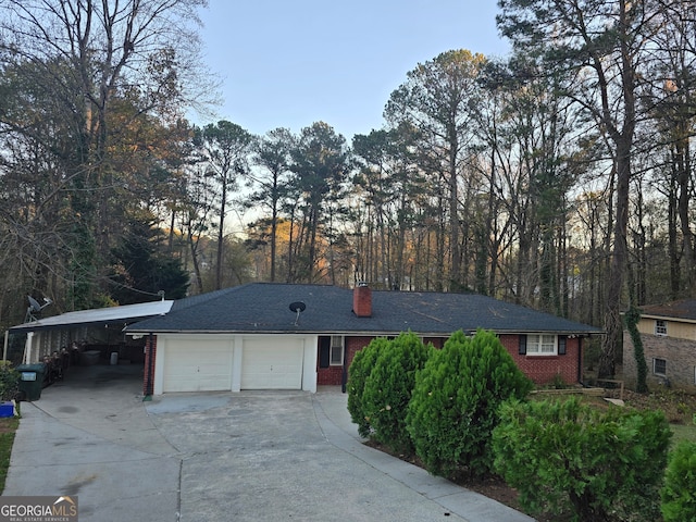 ranch-style house with a garage and a carport