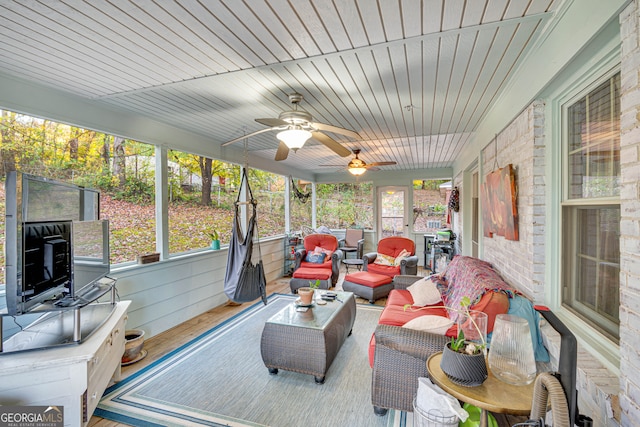 sunroom / solarium with ceiling fan and wooden ceiling