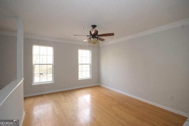 unfurnished room featuring ceiling fan, ornamental molding, a healthy amount of sunlight, and light wood-type flooring