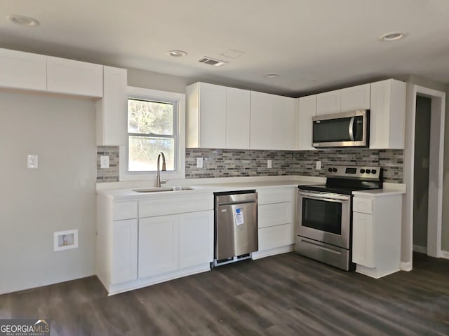 kitchen with white cabinets, dark hardwood / wood-style floors, sink, and stainless steel appliances