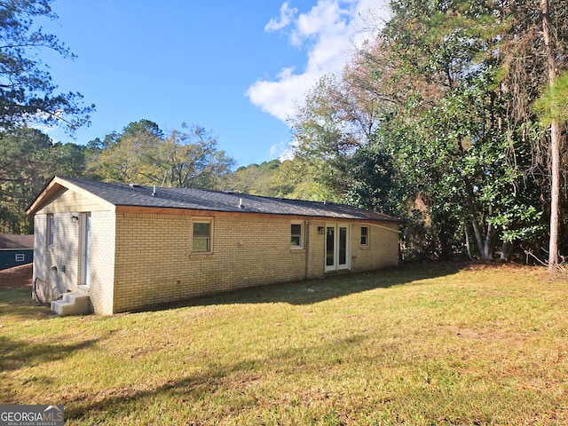 back of house with a lawn