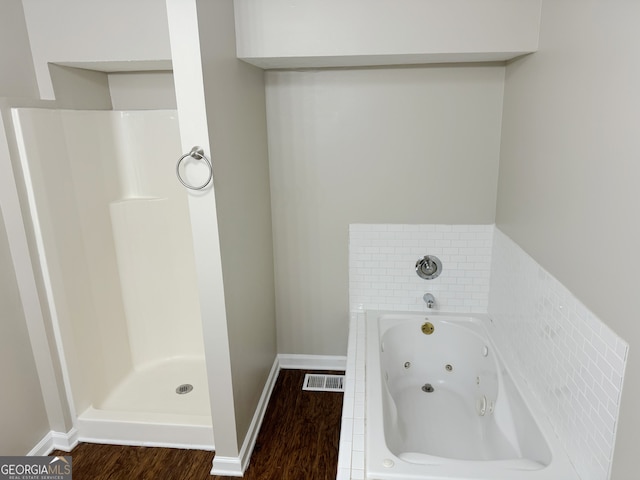 bathroom featuring a washtub and wood-type flooring