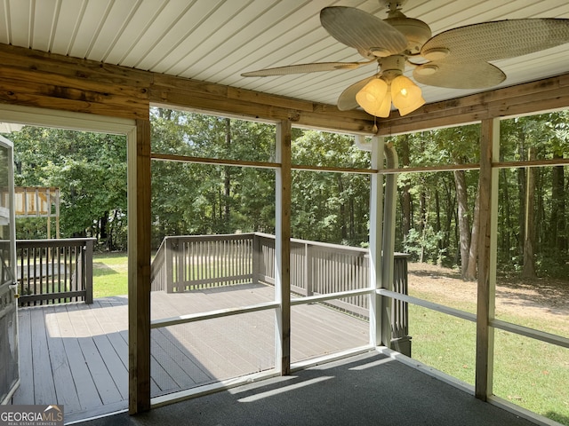 unfurnished sunroom featuring ceiling fan