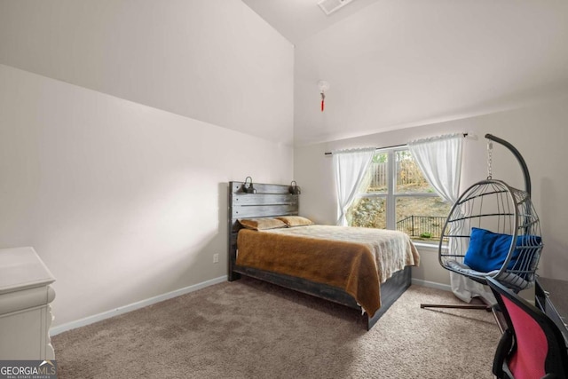 bedroom featuring carpet flooring and high vaulted ceiling