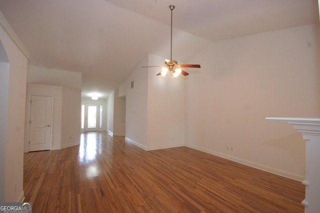 unfurnished living room featuring dark hardwood / wood-style floors, vaulted ceiling, and ceiling fan