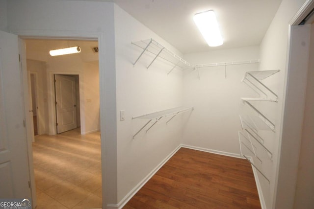 spacious closet with hardwood / wood-style floors