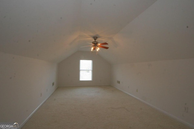 additional living space with light carpet, ceiling fan, and lofted ceiling