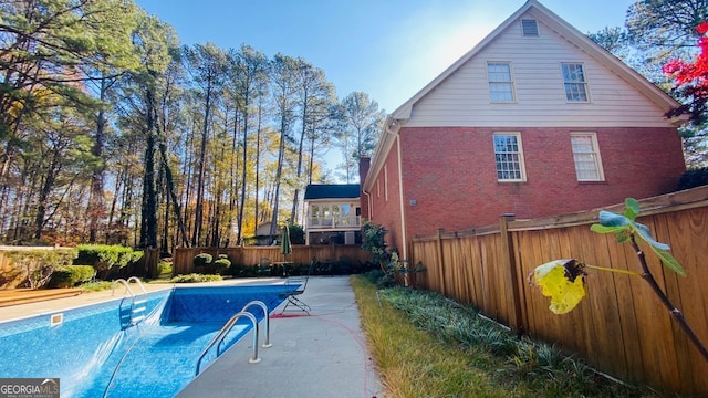 back of house featuring a yard, central air condition unit, and a sunroom