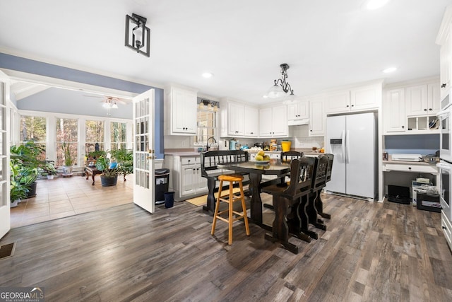 dining area with dark hardwood / wood-style flooring and ceiling fan