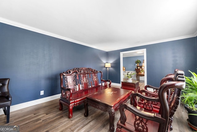 sitting room featuring ornamental molding and hardwood / wood-style flooring