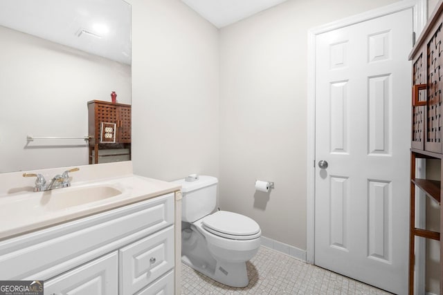 bathroom featuring tile patterned flooring, vanity, and toilet