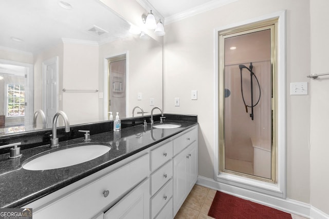 bathroom featuring tile patterned floors, vanity, a shower with door, crown molding, and ceiling fan