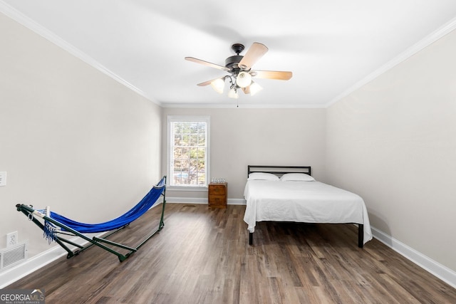 bedroom featuring crown molding, ceiling fan, and dark wood-type flooring