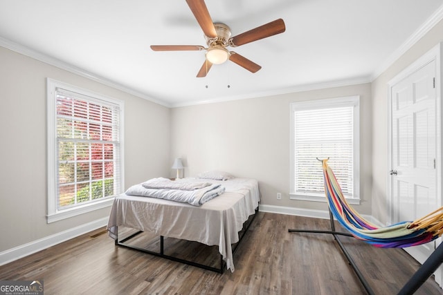 bedroom with ceiling fan, dark hardwood / wood-style flooring, and crown molding