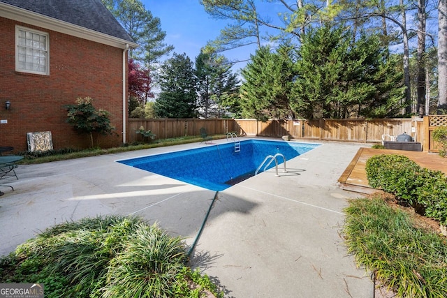 view of swimming pool featuring a patio area