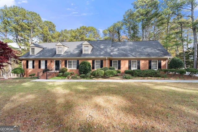 cape cod-style house with a front lawn