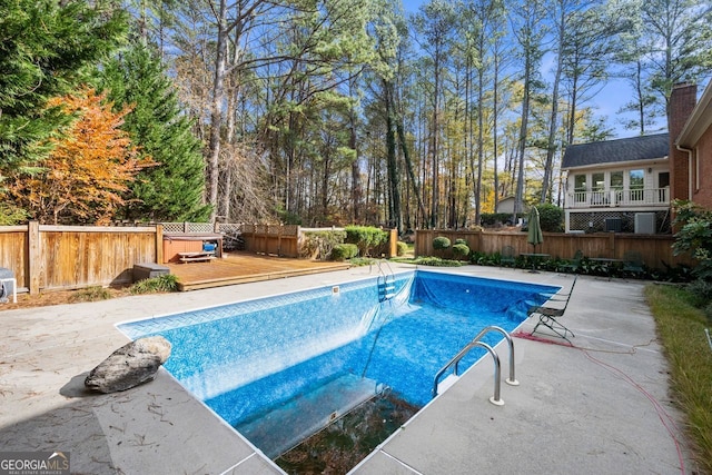 view of swimming pool with a wooden deck