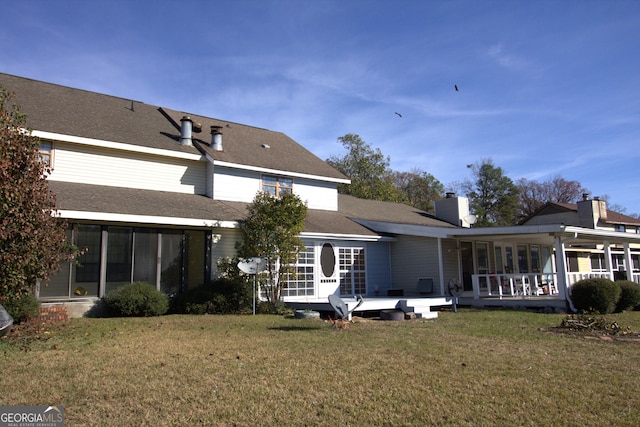 rear view of house featuring a yard