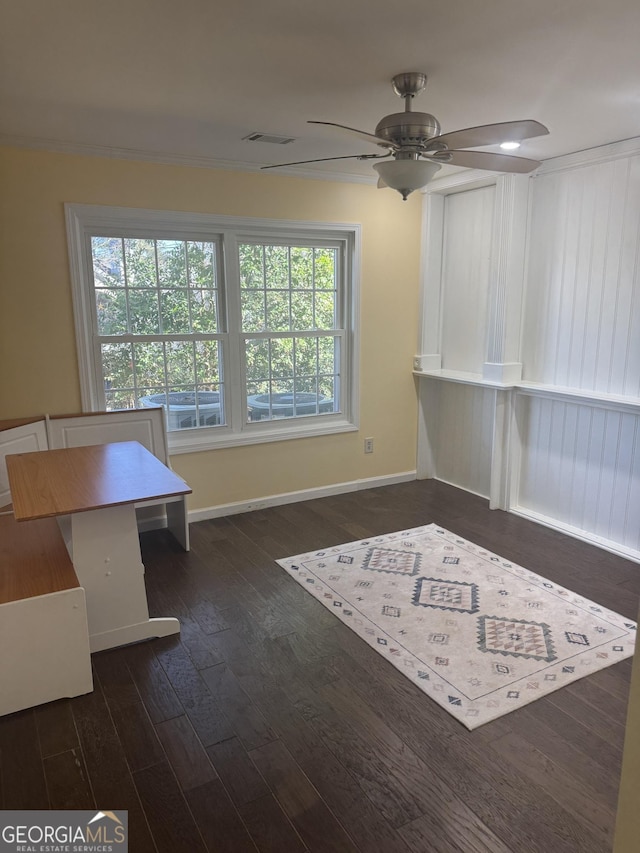 unfurnished office with ceiling fan, dark hardwood / wood-style flooring, and crown molding