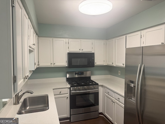 kitchen with white cabinets, sink, and appliances with stainless steel finishes