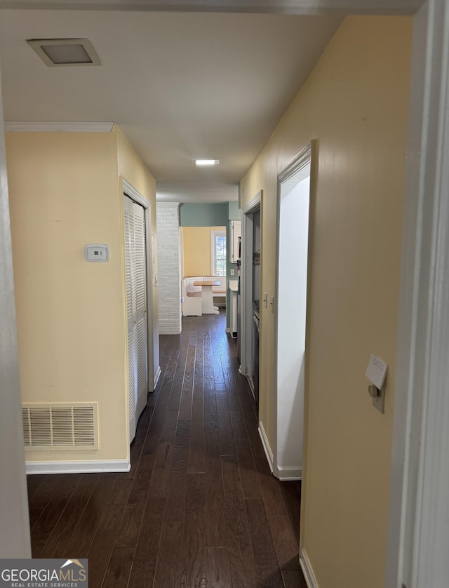 hallway with dark hardwood / wood-style flooring